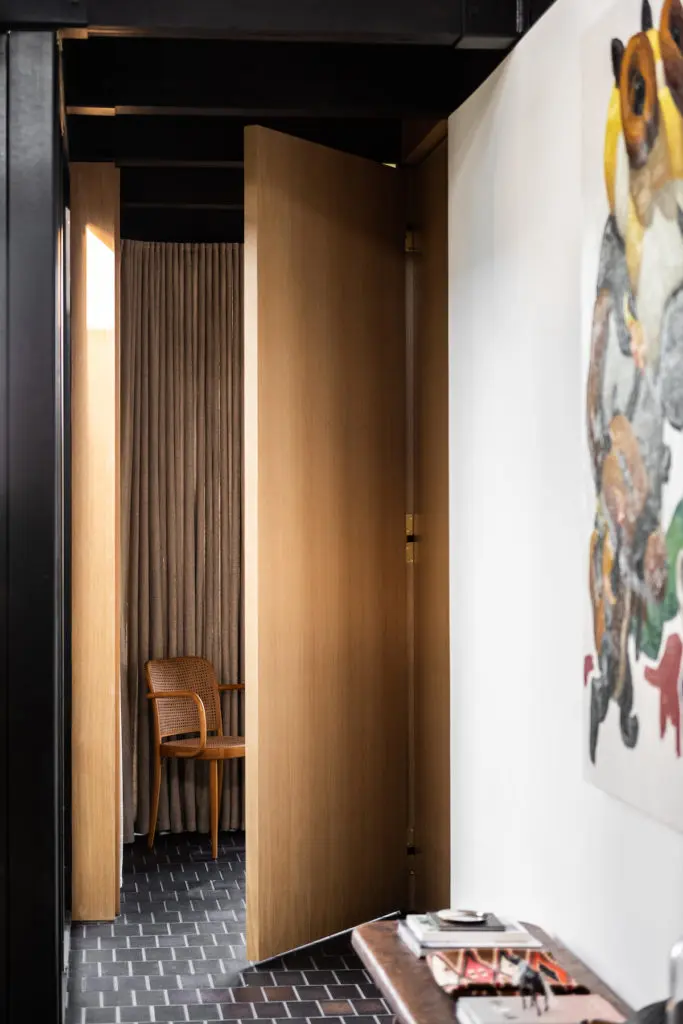 The entry vestibule to the main bedroom can be closed off by a specially designed door with a Harmon hinge, which makes it disappear into the wall when closed. (Photo by Stephen Karlisch and Robert Tsai)