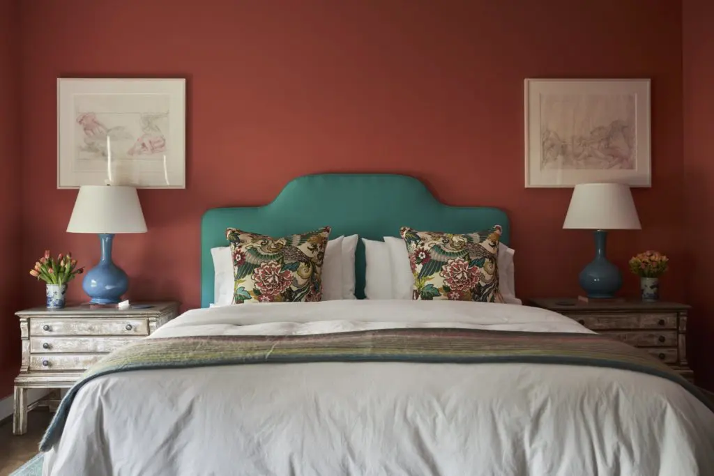 In a bedroom, watercolors are from an estate sale in Palm Beach. Headboard from Memorial Traders, Houston. Alpaca throw from Manos De Sur at Round Top Antiques & Design Center, and at The Compound during shows. On walls Sherwin Williams' Sheraton Sage. (Photo by Pär Bengtsson)