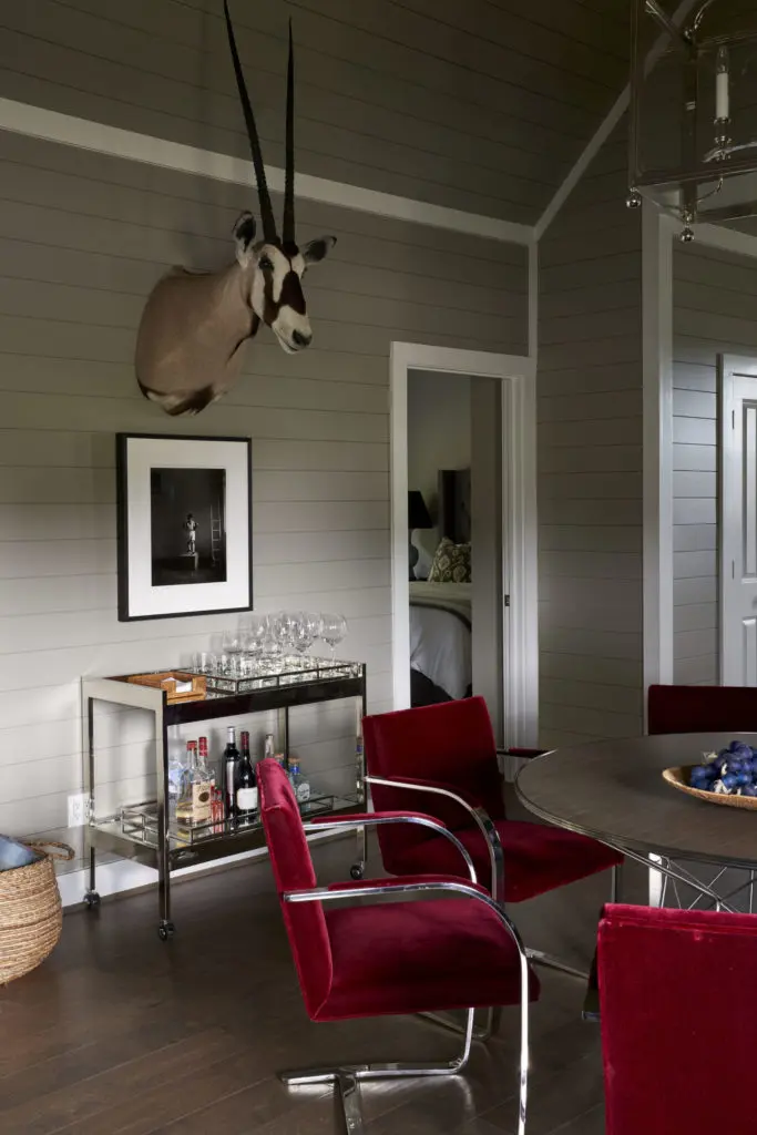 A set of six Mies van der Rohe Brno chairs in their original mohair formed the basis of a modern look and palette in one of the bungalows. Photograph and taxidermy are from Cone and Fourticq's personal collections. (Photo by Pär Bengtsson)