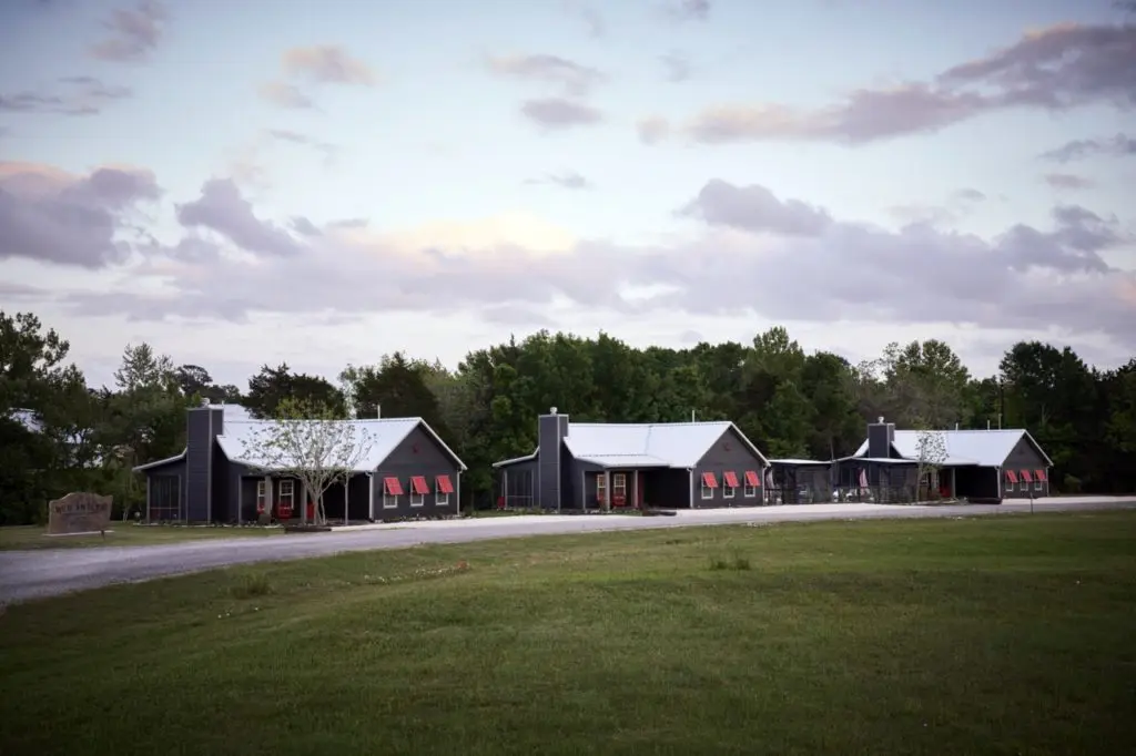 Red Antler Bungalows as seen from Highway 237 is a striking contrast against the landscape, with red doors, shutters, and antlers.