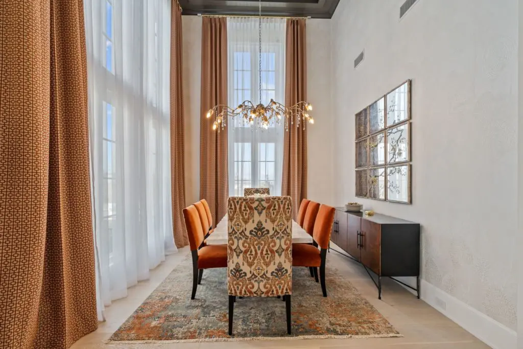 This formal dining room with high double height ceiling and windows add a touch of drama.