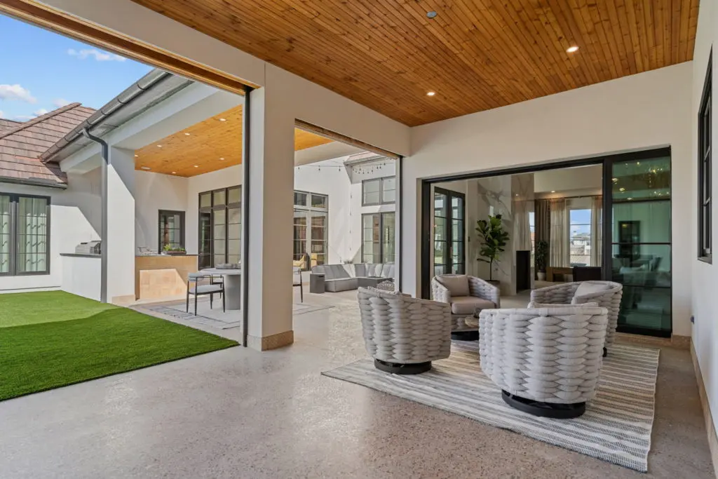 Walls of window open to the outdoor spaces, and outdoor kitchen.