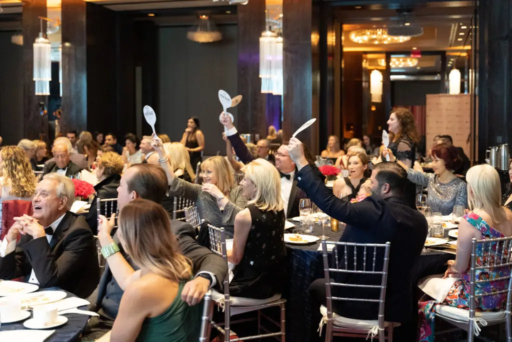 Auction paddles at the ready (photo by Scott Hagar)