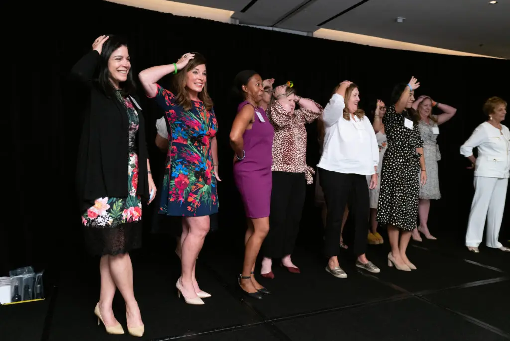 Dress for Success supporters getting into the Heads or Tails game at the DFS Houston fundraiser at the Four Seasons Hotel. (Photo by Daniel Ortiz)
