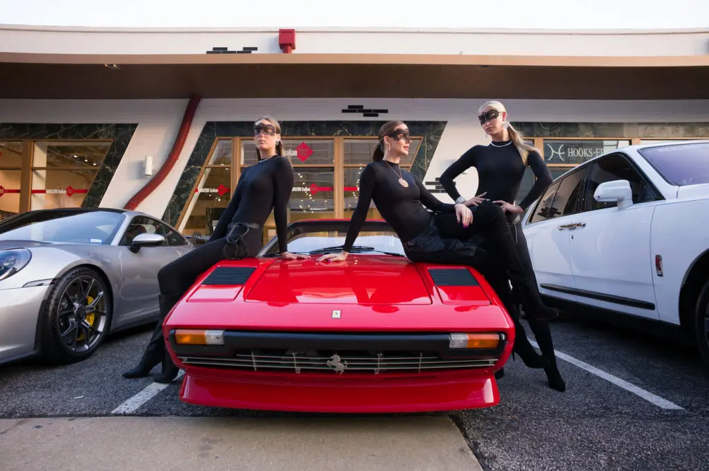 Valobra Cat Burglar models in Valobra jewels pose atop Franco Valobra's cherry red Ferrari.  (Photo by Daniel Ortiz)