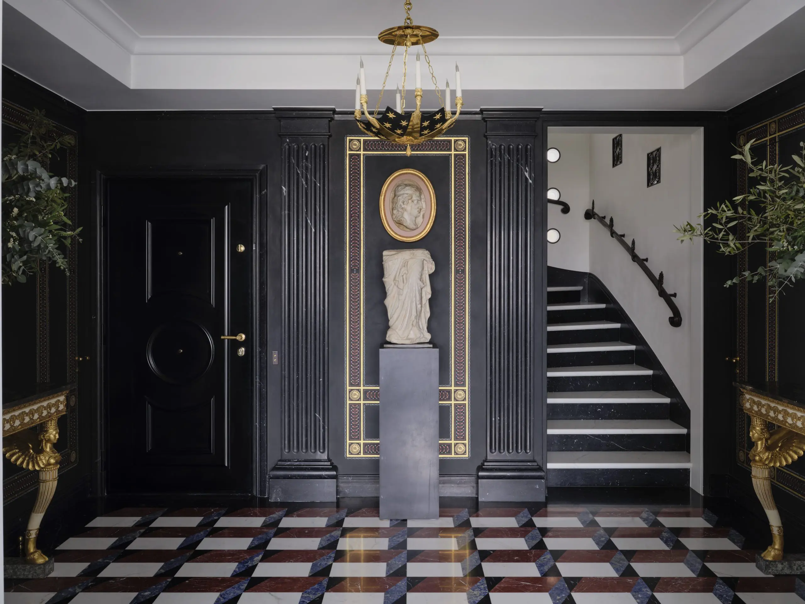In an Athens apartment designed by Alex Papachristidis, decorative artist Delphine Nény painted the marble-floored entrance hall with classical motifs.