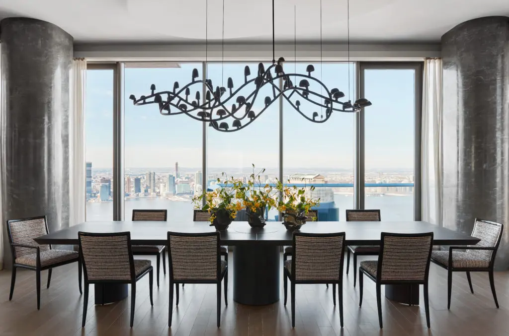 The dining room in this Tribeca project designed by Drake/Anderson takes pride of place with a custom table of ebonite mahogany and gold leaf that can seat as many as 18. (Photo by Stephen Kent Johnson)