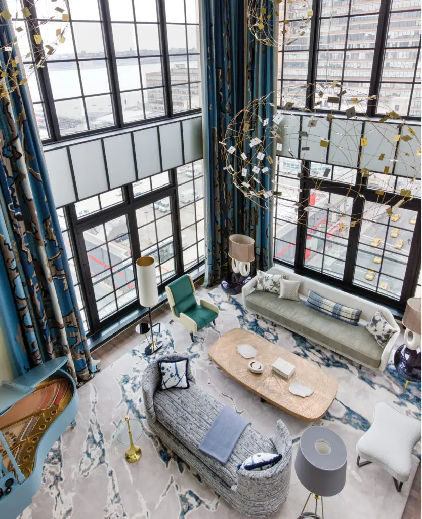 In an Annabelle Selldorf-designed building in New York's Chelsea gallery district, Jean-Louis was inspired by the shimmering water of the river below. Custom-designed JLD brass ceiling lights; bronze coffee table “Goutte d’Eau” by Ado Challe. Curtains are Lesage embroidered on a  thick Pierre Frey linen, with a dégradé color of beige, pearl, and deep blue