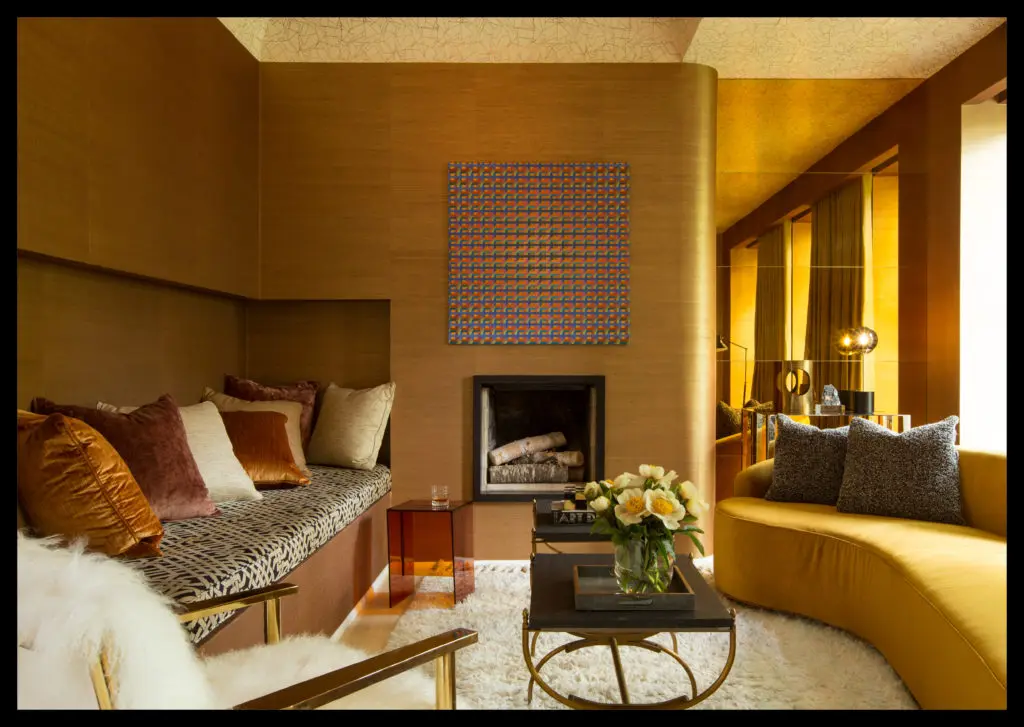 In a Victorian-era townhome designed by Summer Thornton, this tongue-in-cheek, over-the-top space — affectionately dubbed the Gold Room — is perfect for late-night lounging. This room flatters with its dimmed lights and gold grasscloth wallpaper. Sitting here, you look like you’ve just returned from a month in Greece. The banquette is built into the wall. Everything is very tactile — velvet fabrics, shag carpeting, a sheepskin chair. The furniture shapes are all curvy, soft, and sinuous. (Photo by Thomas Loof)