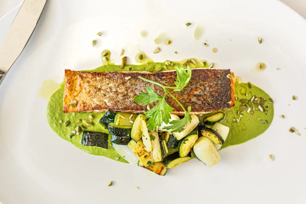 The Scottish salmon entree is served with a green mole, zucchini and pumpkin seeds at The Annie Cafe and Bar. (Photo by Jenn Duncan)