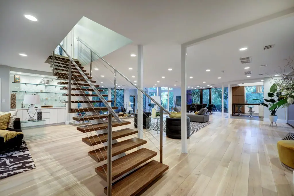The floating stairway at 11686 Arrowwood Circle in Piney Point Village speaks of today's contemporary designs.  (Photo by TK Images for Martha Turner Sotheby’s International Realty  )
