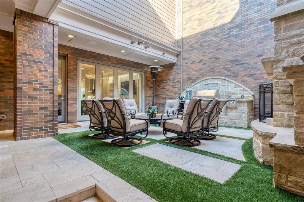 The shaded fully enclosed courtyard with wood burning fireplace and outdoor kitchen.
