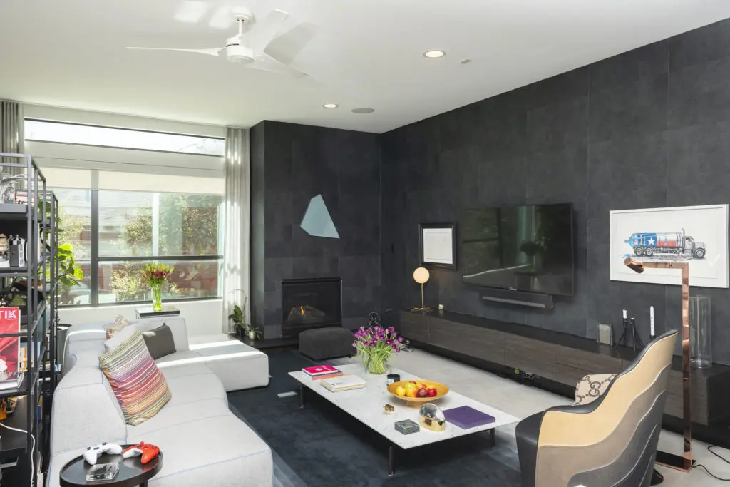 Owners of 1922 Fairview covered walls of the living room in striking charcoal gray paper setting off the art collection.  (Photo by Anthony Rathbun)