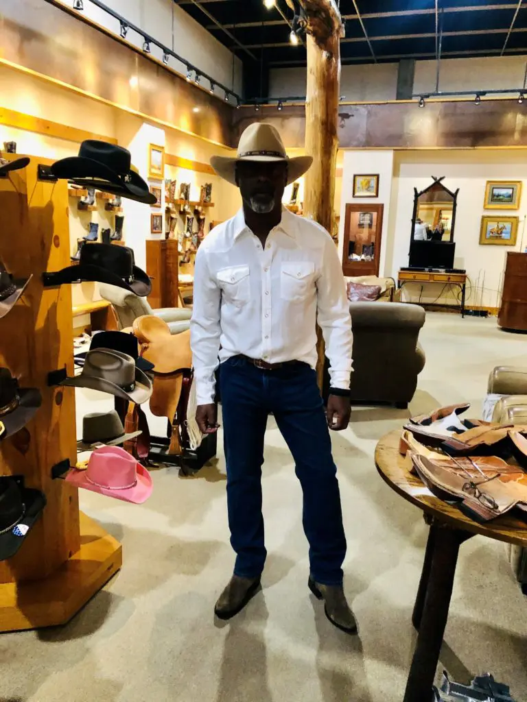 Isiah Washington styling his new Western hat at Pinto Ranch. (Photo courtesy of Pinto Ranch)