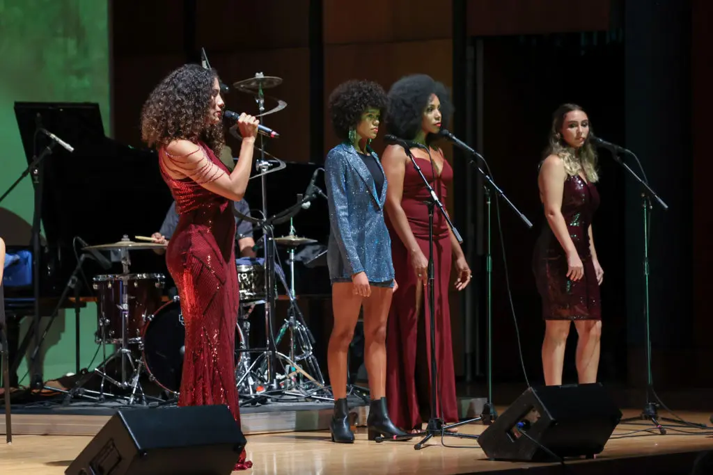 Khaili Sam-Sin, also known as SAM/SIN, sings with Triniti Hymes-Richardson, Krystal Hardwick, and Molly Shanahan. (Photo by Johnny Than)