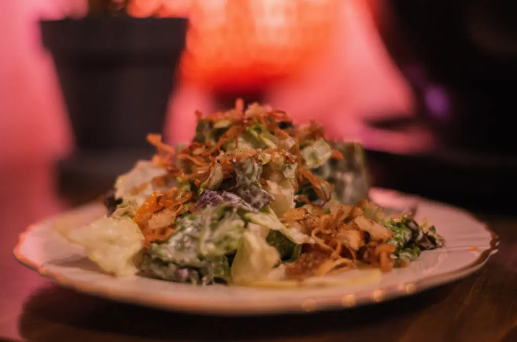 The Sesame Caesar with pickled kohlrabi, cherry tomato, and burnt sourdough is one of the five courses to be served at the ReikiNa pop-up. (Photo by  Dylan Scardino)