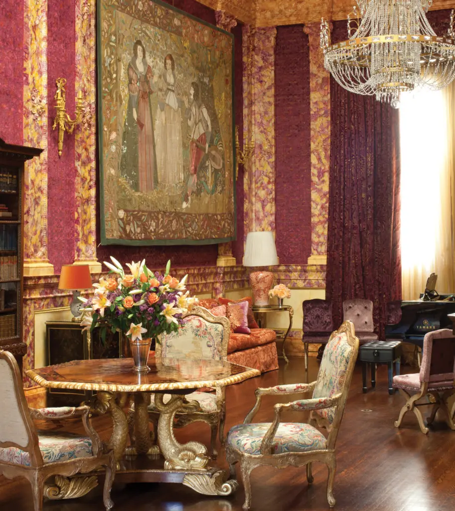 The grand three-story music room/ballroom/reception room runs along the entire west wing of Peter Getty's sun-filled residence. The interior was redesigned by Ann Getty in a bravura theatrical style, with newly-painted faux-marble columns and cornices by decorative artist Shirley Robinson. (Photography by Lisa Romerein)