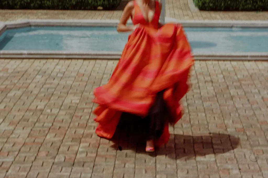 Models in Brandon Maxwell's vibrant Pre-Spring 2023 collection — which naturally launched for pre-order on Moda Operandi that day — played lawn games under a spreading oak tree. (Photo by Kristen Kilpatrick)