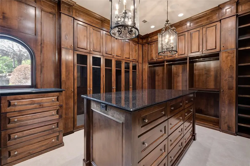 The mens closet perfectly embodies the home's old world charm.