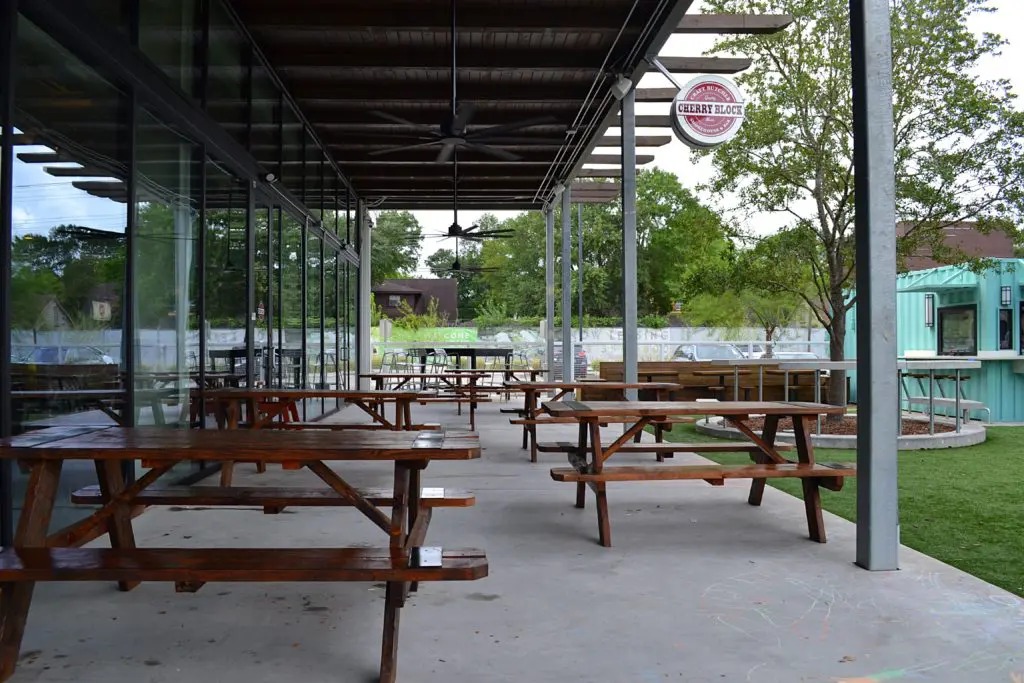 Cherry Block Smokehouse patio opens up to the greenspace at Stomping Grounds.Photo by POP Studios PR