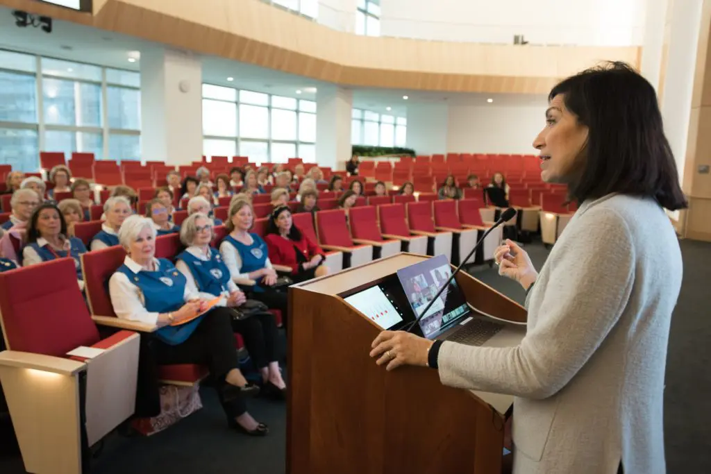 Dr. Huda Zoghbi addresses the gathering at the Blue Bird Circle Know Your Clinic Day at the Duncan NRI at Texas Children's Hospital. (Photo courtesy of Texas Children's Hospital)