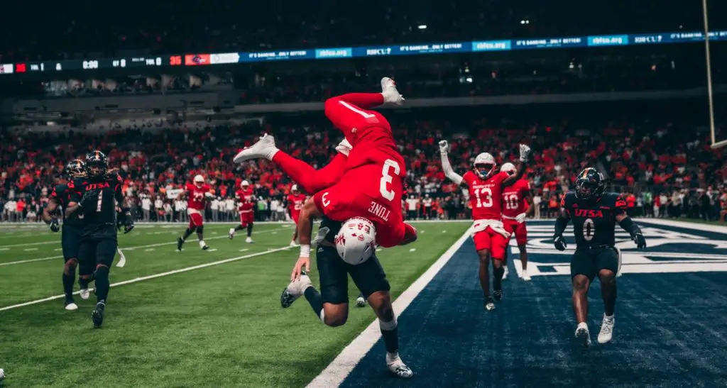 On the two-point conversion play that provided the winning margin, UH quarterback Clayton Tune more than sold out to get the score. He went airborne. (Courtesy UH Athletics)