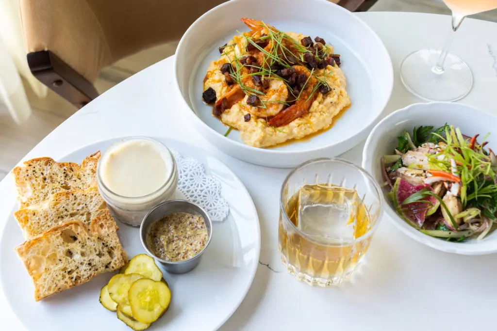 On the menu at the Rooftop Lounge at Georgia James, left to right: Pork Rillette, Shrimp and Grits, and Marinated Crab Legs.  (Photo by Michael Anthony)
