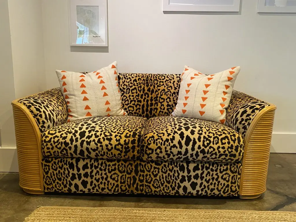 The '70s era rattan sofa and love seat have been upholstered in a velvety leopard print in the Mary Patton Design shop.