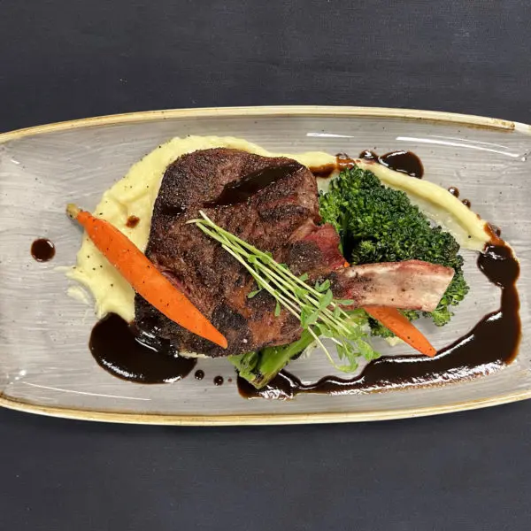 Lone Star Bone-In Ribeye with Roasted Garlic Potato Puree & Charred Broccolini and Carrots