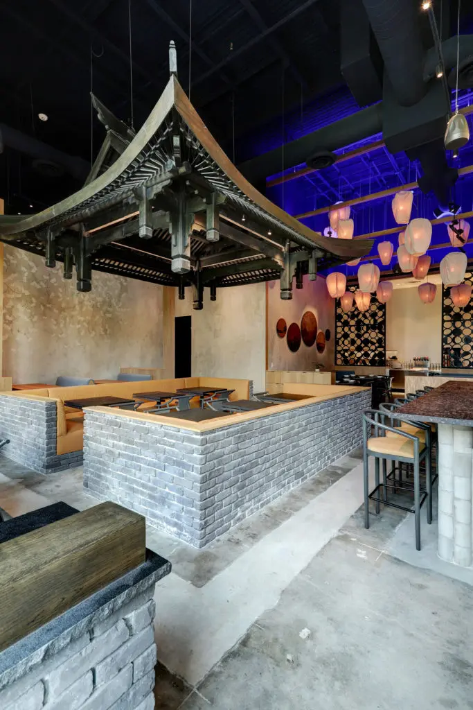 Gin Design Group created a full-size wooden Pagoda roof, handmade by Sichuan artisans. Put together solely with wooden joinery it floats above the dining room. (Photo by Bill Krampitz)