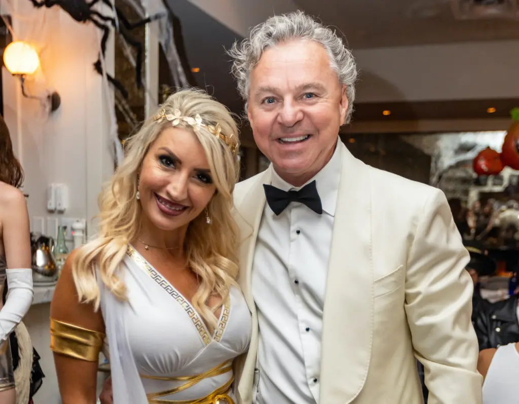 Jane Vanden Berghe, Brasserie 19 owner Charles Clark, dressed as Jay Gatsby, at the restaurant's annual Halloween party (Photo by Andrew Hemingway)