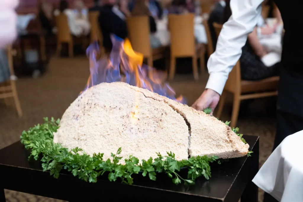 Tony's flaming salt-crusted Gulf red snapper served at AVDA's 'Honoring Texas Victims' dinner (Photo by Daniel Ortiz)