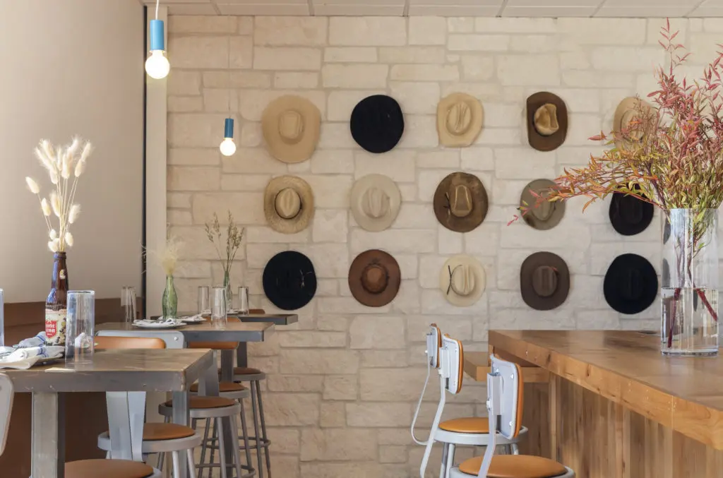 A corner of the bar area at Wild Oats features a collection of Stetson hats. (Photo by Claudia Casbarian)