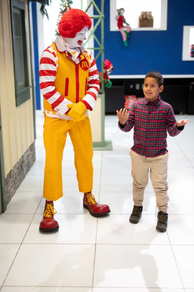 Ronald McDonald and Vasco Castaneda, the 2022 honorary kid conductor for the Trains at NorthPark. (Photo by Bret Redman)