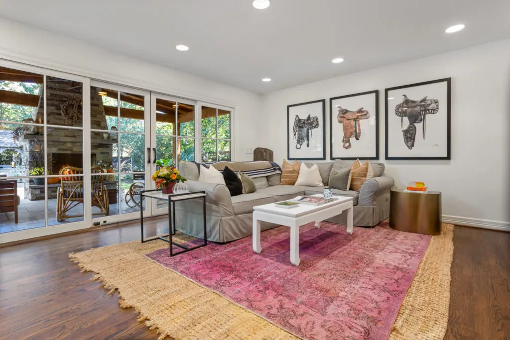 Den with warm oak under foot and a 12 foot sliding doors leading the to the covered patio.