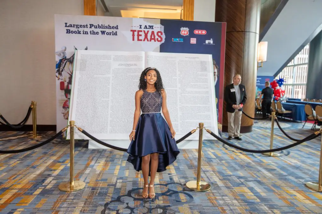 Author Madison Dedman in front of the 7-foot tall 'I Am Texas' book (Photo by Dave Rossman)