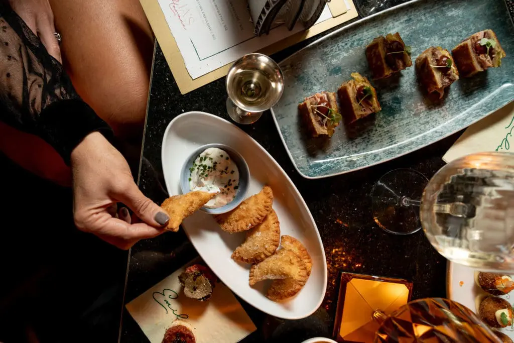 Lobster corn empanadas and duck Cubanos are on the limited menu of light bites at Emilia's Havana. (Photo by Brian Kennedy)