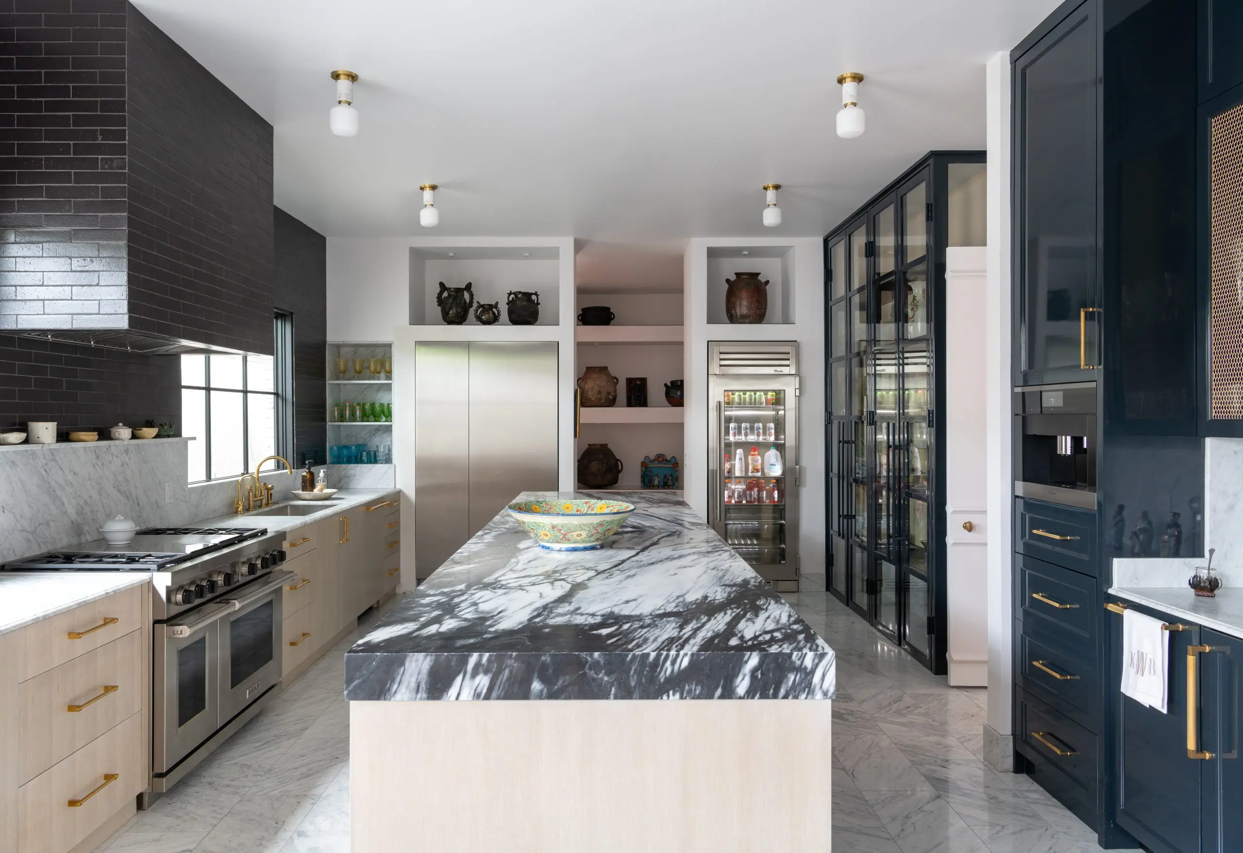The soapstone island is the centerpiece of the modern meets traditional kitchen. (Photo by Michael Hunter)