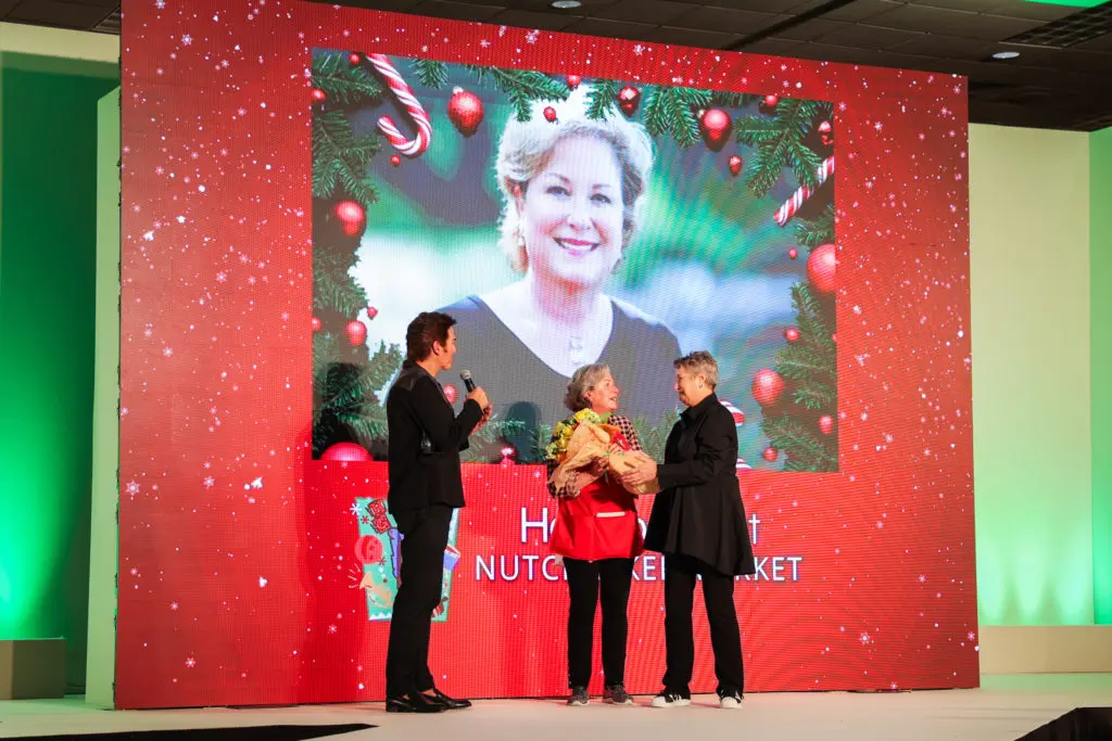 Lenny Matuszewski, Houston Ballet Nutcracker Market honoree Patsy Chapman, Tamara Klosz Bonar with the yellow rose bouquet presentation at the Macy's market brunch.
 (Photo by Melissa Taylor)