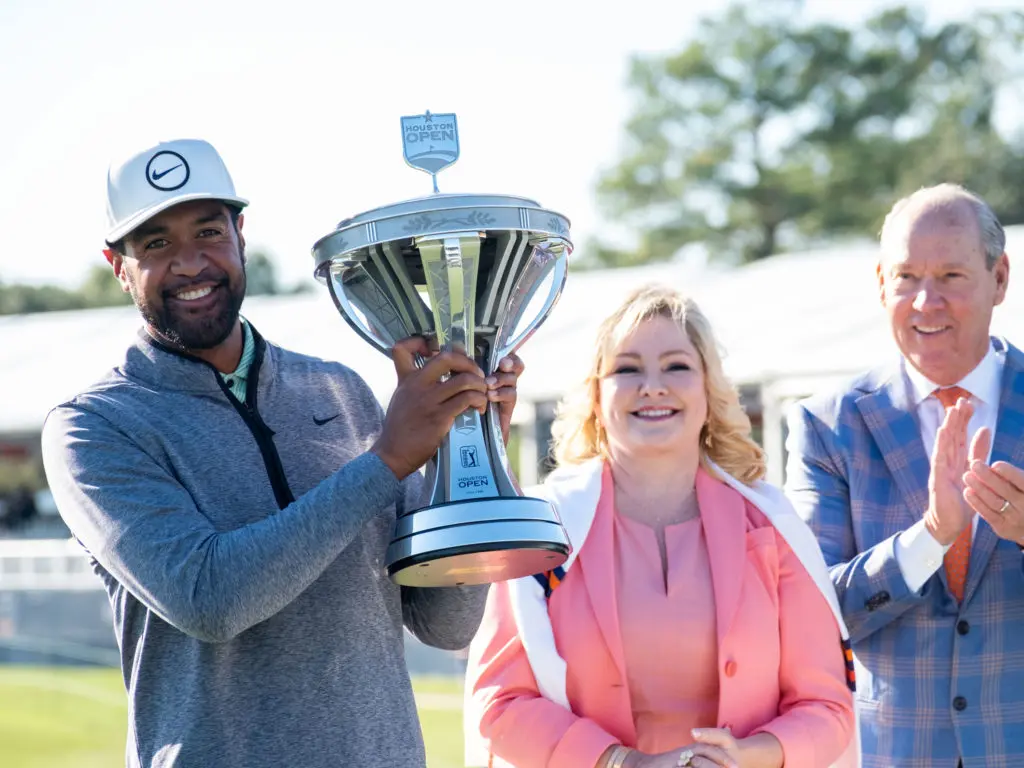 New Houston Open champion Tony Finau lifted the trophy and Whitney and Jim Crane congratulated him. (Photo by F. Carter Smith)