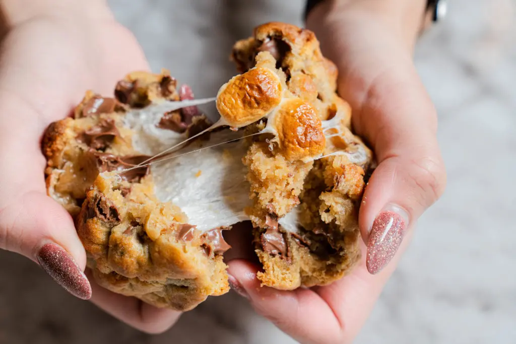 Milk Mustache's Campfire Bliss cookies are hand rolled with premium milk chocolate, honey graham crackers, and a toasted marshmallow stuffed in the center. (Photo by Michael Anthony)