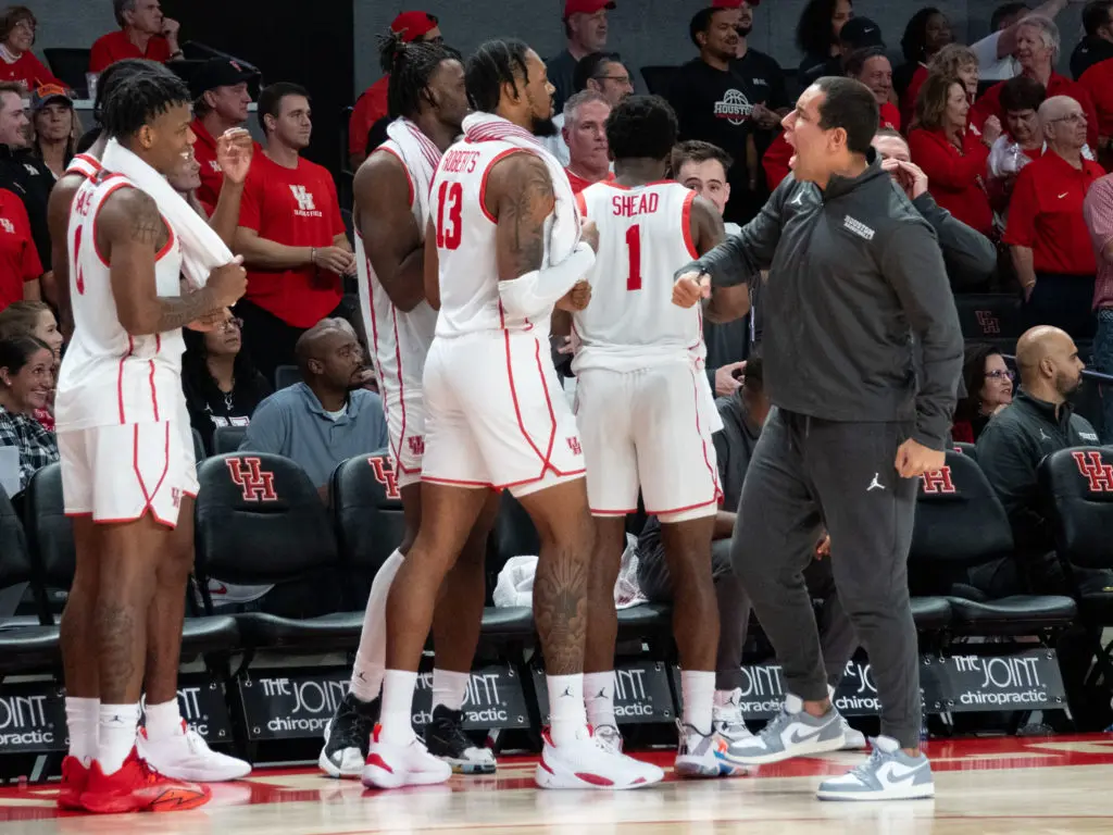 UH assistant coach Kellen Sampson brings a lot of intensity and sometimes cracks Marcus Sasser up with the force of that enthusiasm. (Photo by F. Carter Smith)