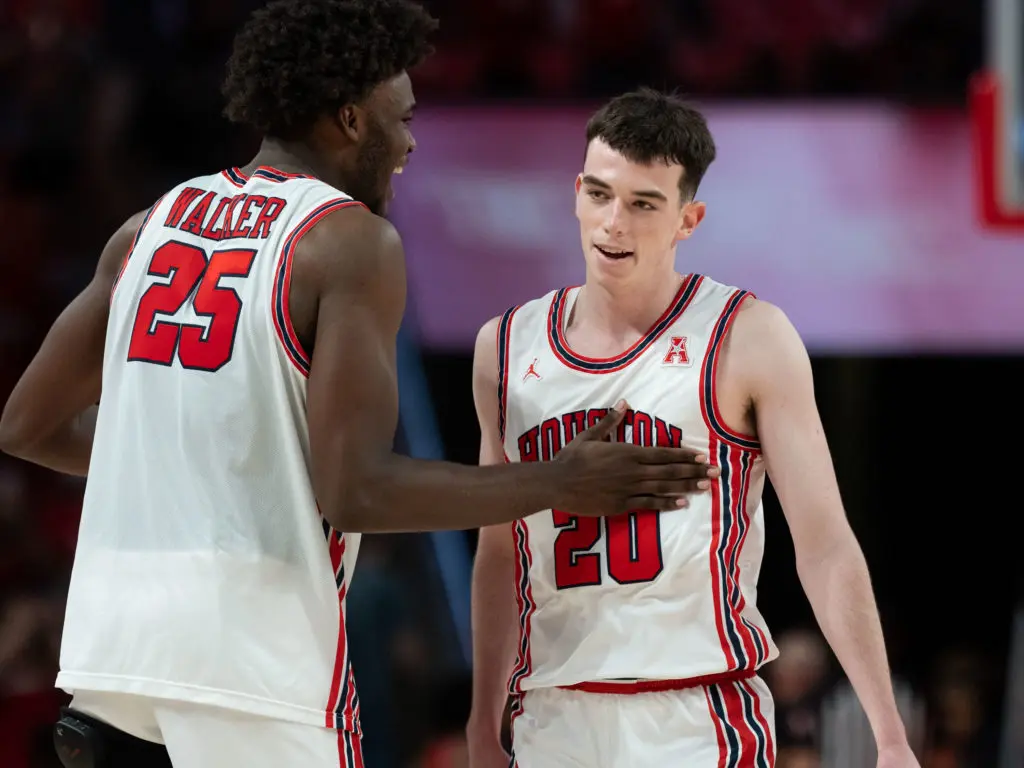 The joy this No. 1 ranked UH team plays with is apparent. Here, super freshman Jarace Walker delights in junior guard Ryan Elvin's late game moments. (Photo by F. Carter Smith)