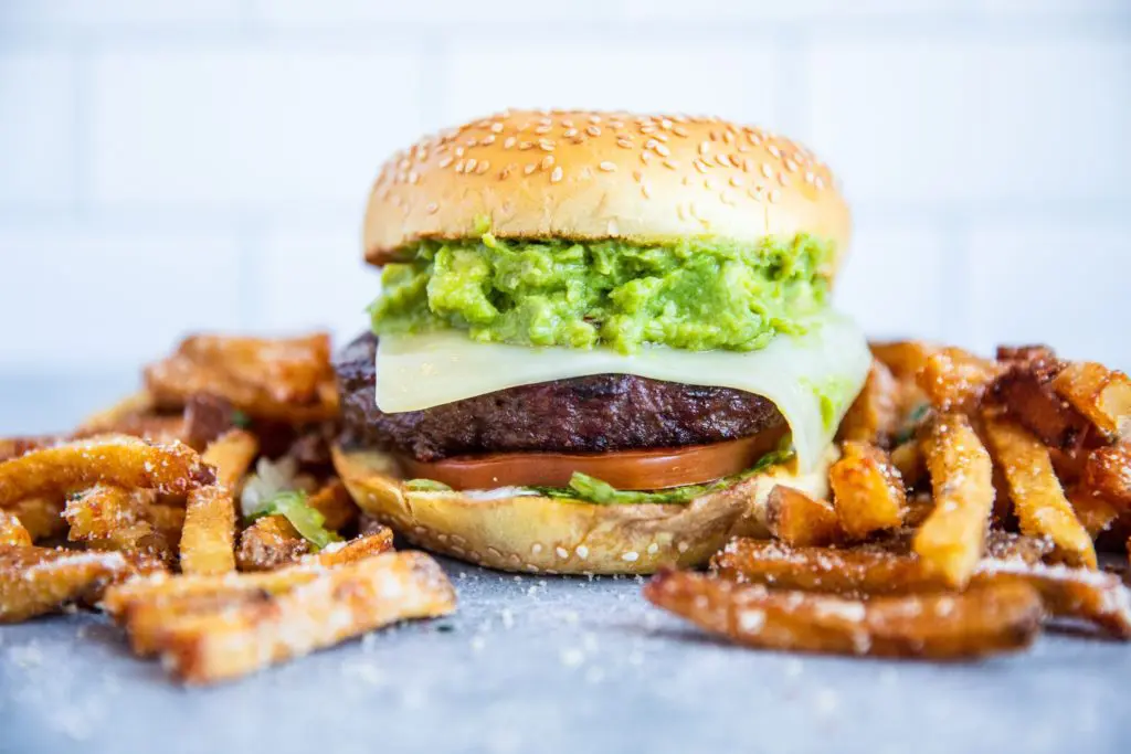 Becks Prime's California burger with Swiss cheese, guacamole, lettuce, and tomato is one of the beloved Houston chain's offerings. (Photo by Becca Wright Photography).