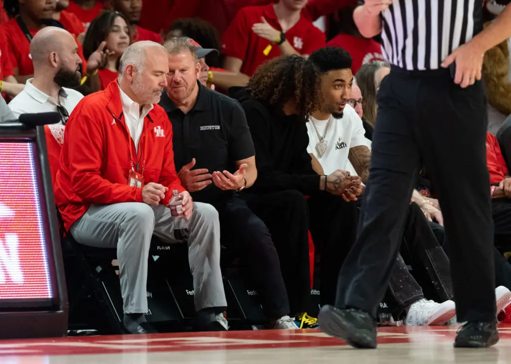 UH athletic director Chris Pezman, Tilman Fertitta and Rockets players Jalen Green and KJ Martin took in a Top 10 clash at the Fertitta Center. (Photo by F. Carter Smith) 