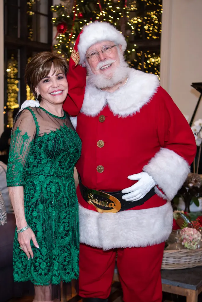 Hallie Vanderhider with Santa at the Santa's Elves Party, held at The Fertitta Family home in River Oaks,  benefitting MD Anderson Children's Cancer Hospital.