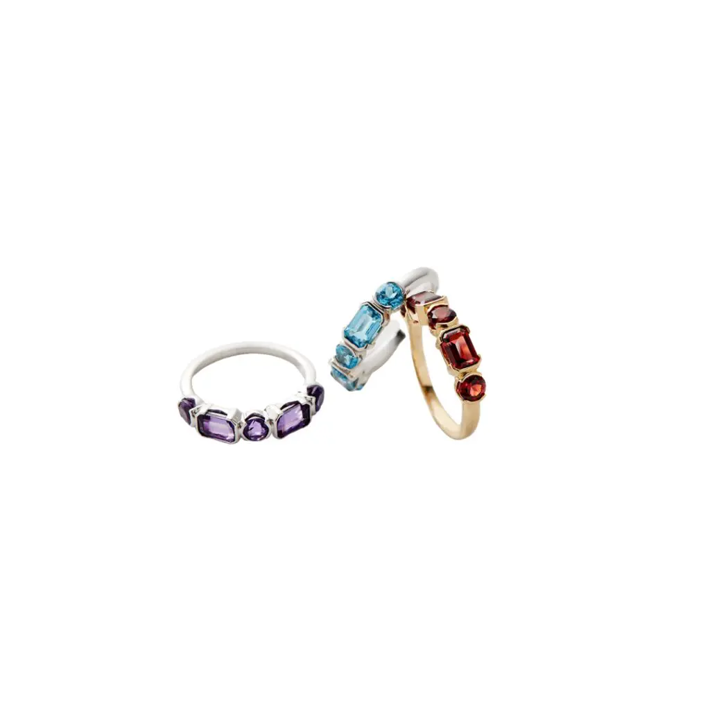Fallon B. 18K white gold rhodium plated parital bezel Swiss blue topaz stacking band with 2 emerald cut Swiss blue topaz approximately weighing 1.44 carats total weight, 3 round Swiss blue topaz weighing approximately 0.88 carat total weight, SZ 6; $1,400