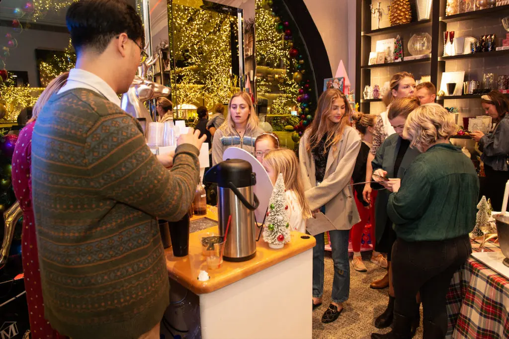Shoppers grabbing hot cocoa at Madison 214.  (Photo by George Fiala)