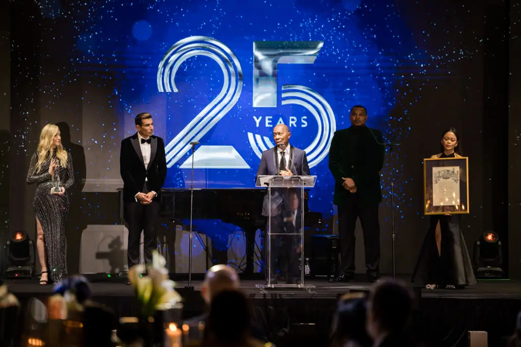 Mayor Sylvester Turner receives the Champion of Service Award at the ZT Corporate Chairman's Ball on stage with  
Taseer Badar and emcee Chester Pitts at the Hilton Americas-Houston. (Photo by Composure Studios and Black Frame Photo)