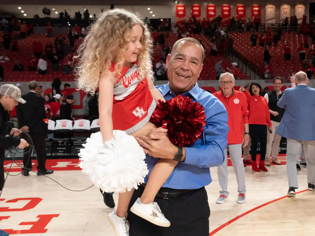 Maisy Jade and her grandfather — UH coach Kelvin Sampson — certainly enjoyed Houston's comeback win over Cincinnati. (Photo by F. Carter Smith)